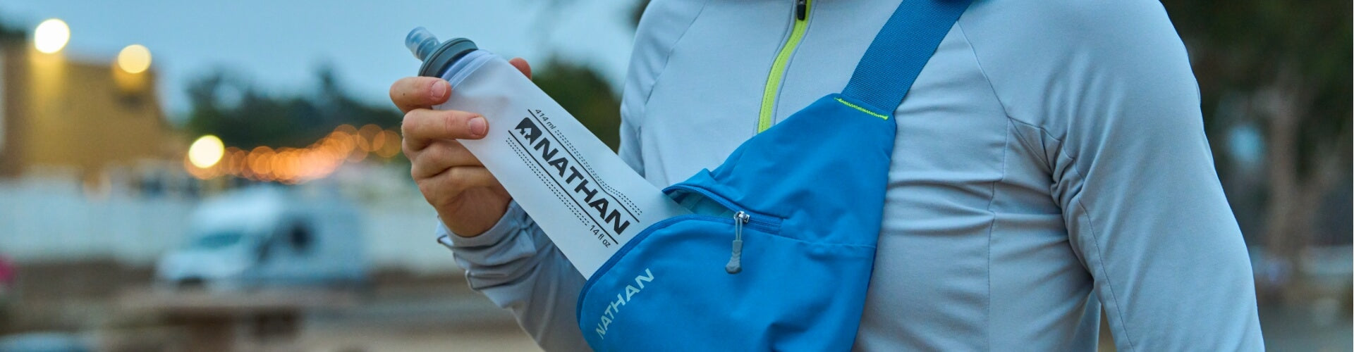 Runner Pulling Hydration Bottle From Run Sling