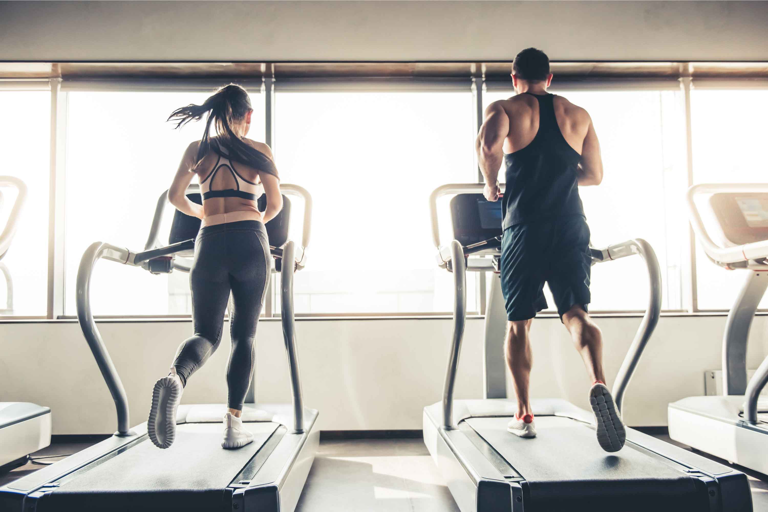 Couple on Treadmill Working Out Together